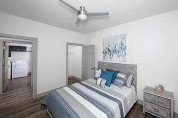 A bedroom with a bed and a ceiling fan